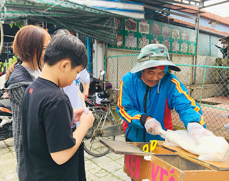 Một hàng rong bán kẹo kéo trên phố. Loại kẹo được làm thủ công, được những lũ trẻ con ngày xưa cực yêu thích.